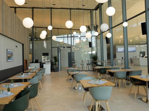 Blick auf Tische und Stühle im Innenbereich des Restaurants Tabor im Schwaketenbad